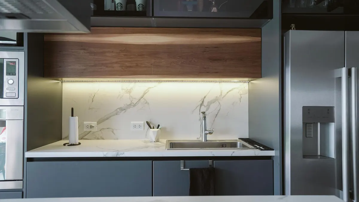 Dark painted kitchen cabinets demonstrating how sheen responds to task lighting