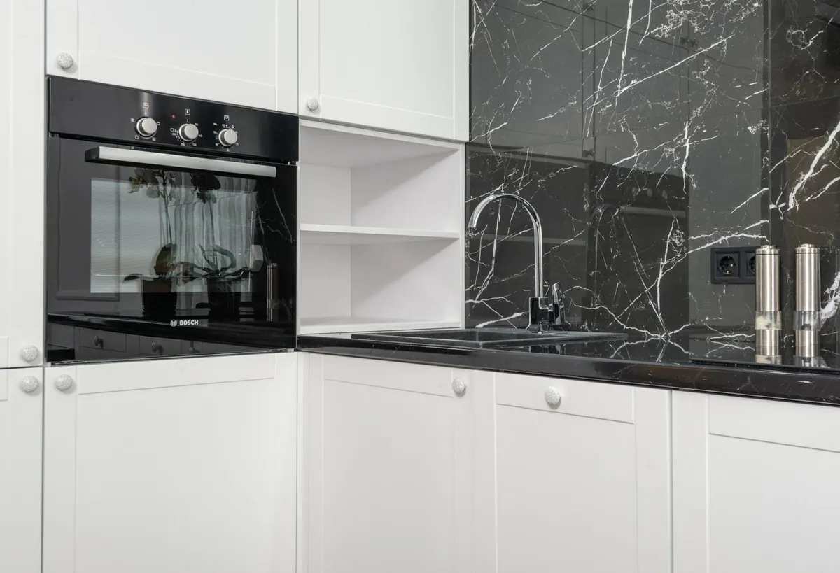 White kitchen cabinets showing a clean low-sheen painted finish