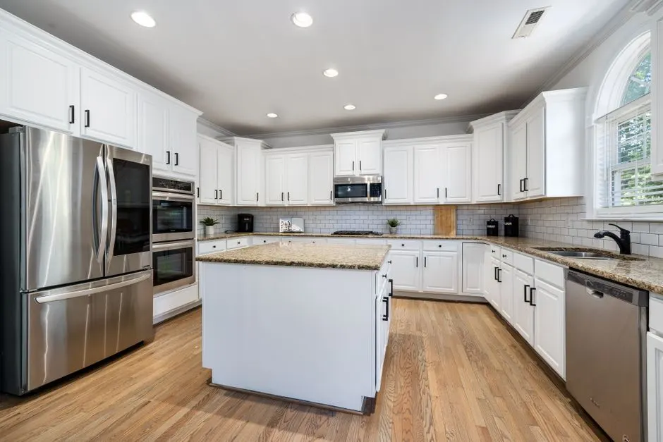 Bright kitchen cabinets after a clean cabinet painting project