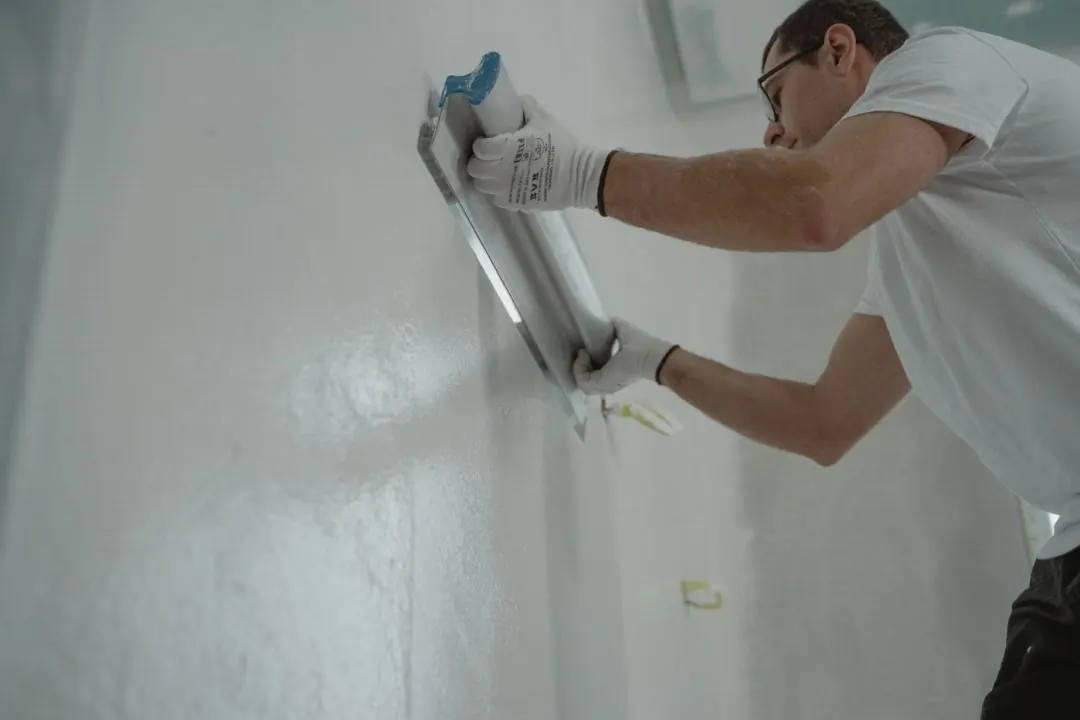 Professional smoothing and feathering a repaired interior wall