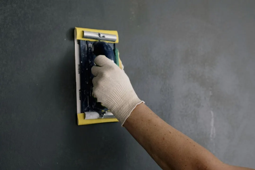 Drywall surface being smoothed before primer and paint