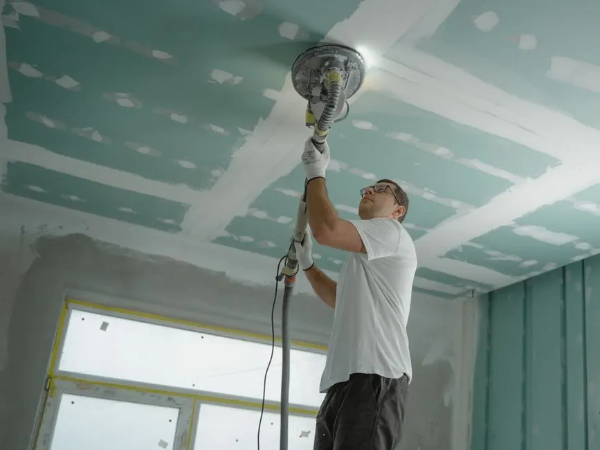 Professional drywall sanding and finishing before interior painting