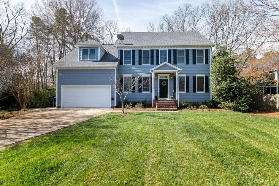 Gray exterior home with fresh paint and trim under mild weather