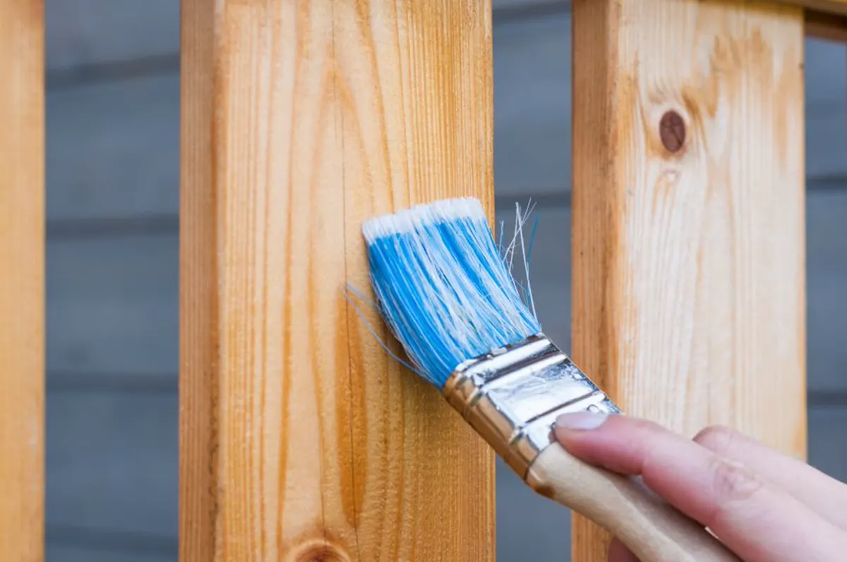 Paintbrush applying finish for fence painting cost planning