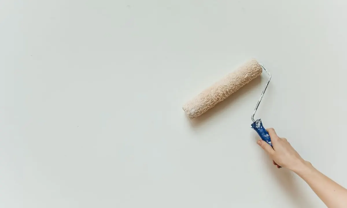 Close-up of a paint roller applying a smooth interior finish