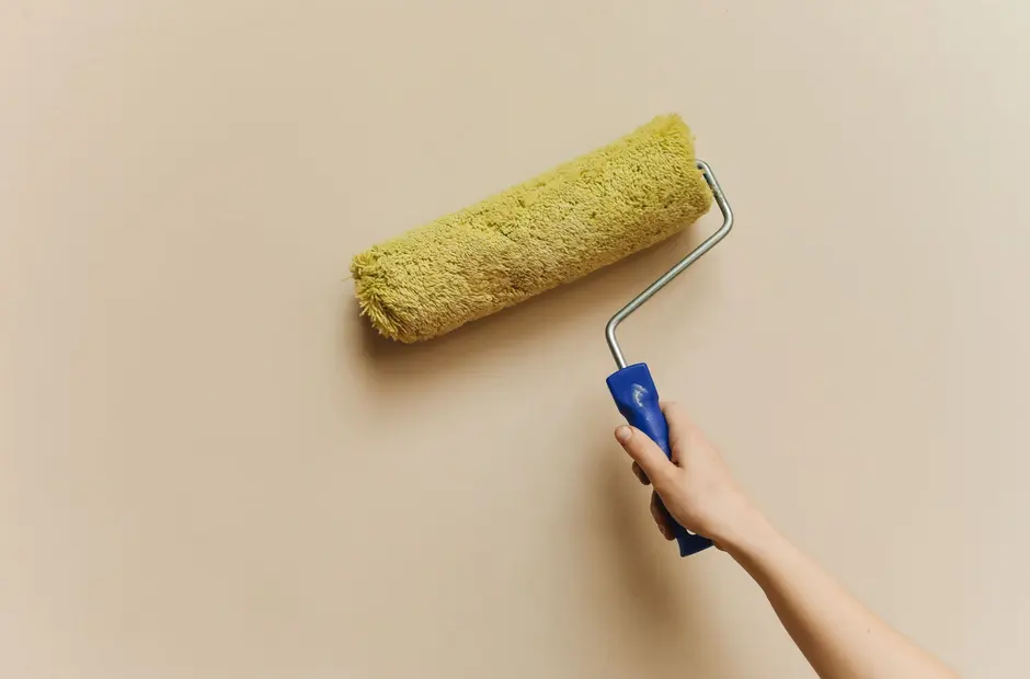 Interior wall painting with a roller during a home repaint