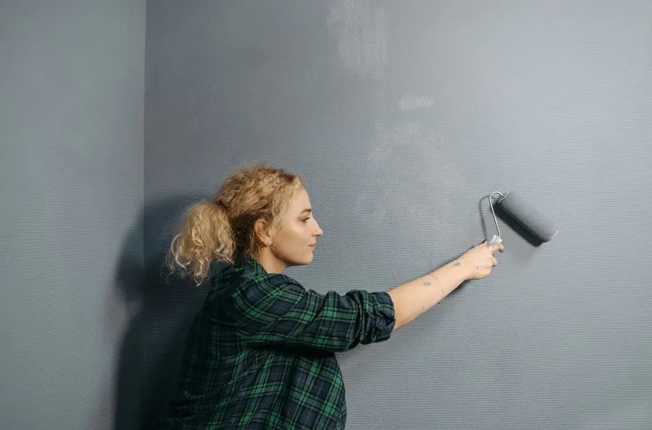 Painter preparing a wall before applying finish coats