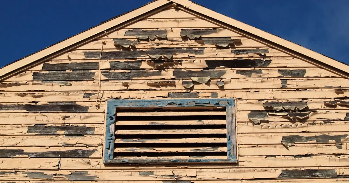 Weathered exterior siding that needs preparation before house painting