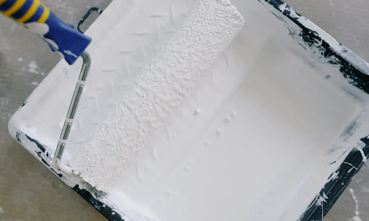 Paint roller and tray prepared for an interior painting project
