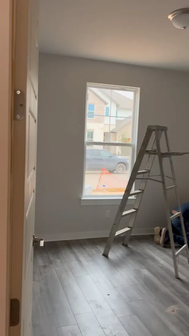 Interior room in the finishing stage of a new construction painting project