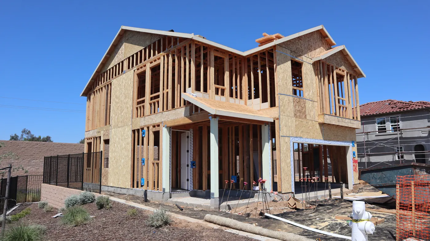 Two-story suburban home in the framing stage before new construction painting begins