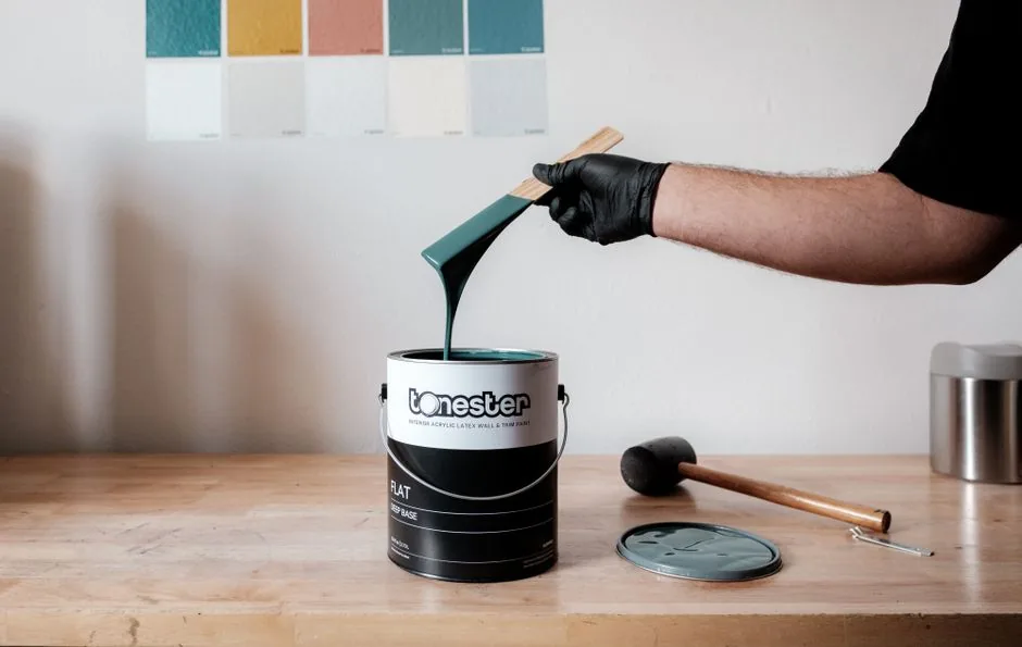 Painter brush and paint bucket detail for choosing an interior paint finish