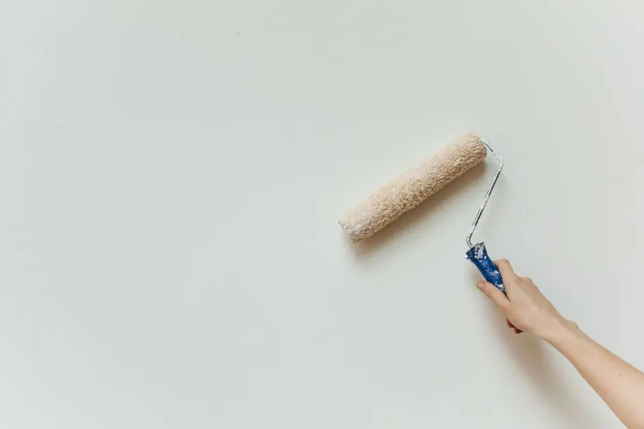 Close-up of a roller applying paint to a prepared wall