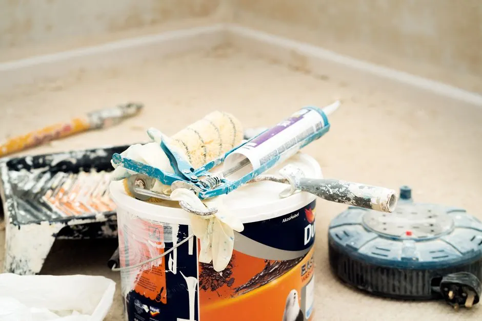 Paint rollers, primer, and prep materials for a home painting project