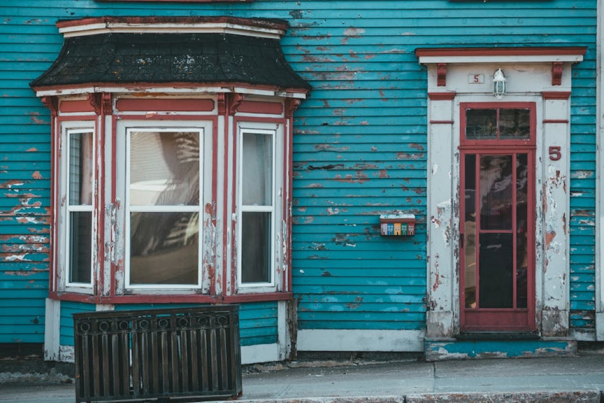 Weathered exterior facade showing fading and aging paint