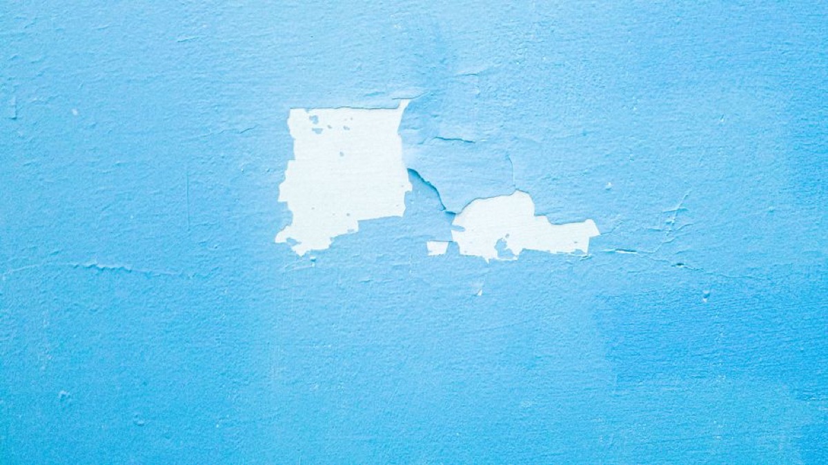 Close up of peeling paint showing layers of exterior paint failure