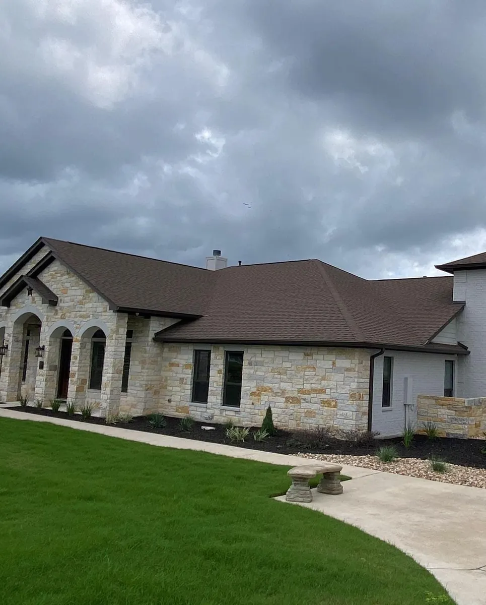 Finished Austin-area stone and painted brick home exterior by New Life Painting