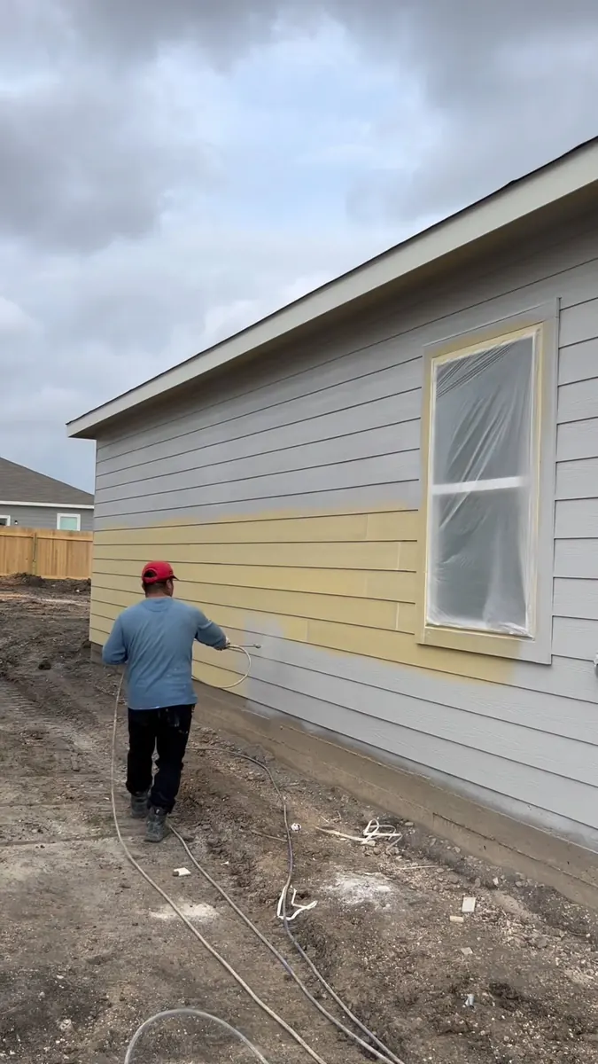 New Life Painting crew applying an exterior coating to residential siding in the Austin area